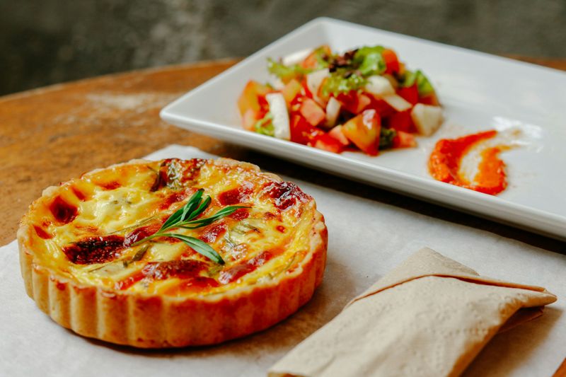 A savoury tart served with a small salad